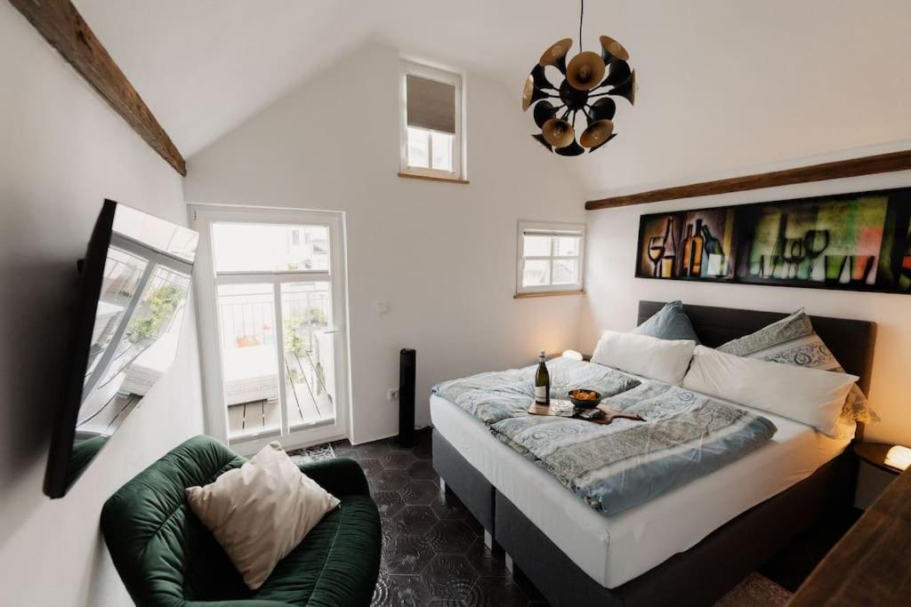 Un dormitorio con una cama y una silla verde. en Modernes Tiny House mit Sonnenterrasse, en Ediger-Eller