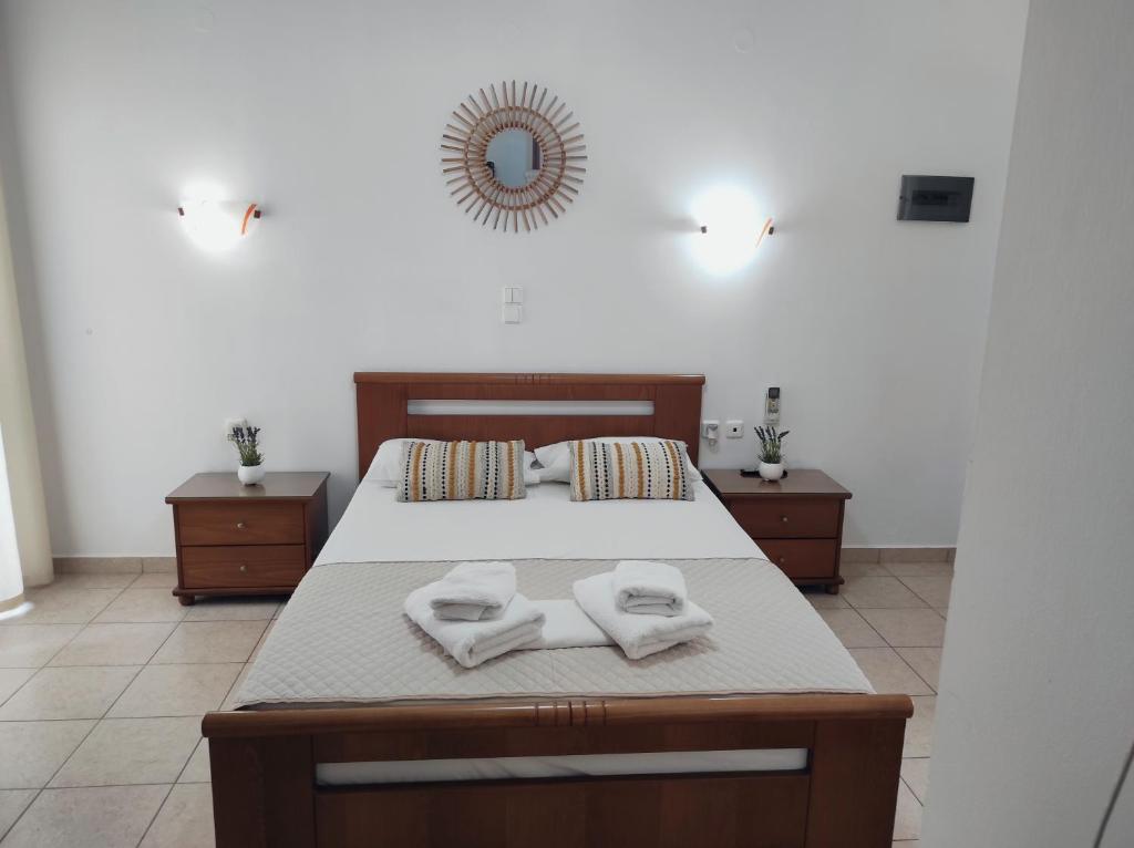 a bedroom with a bed with two towels on it at Vythos in Adamas