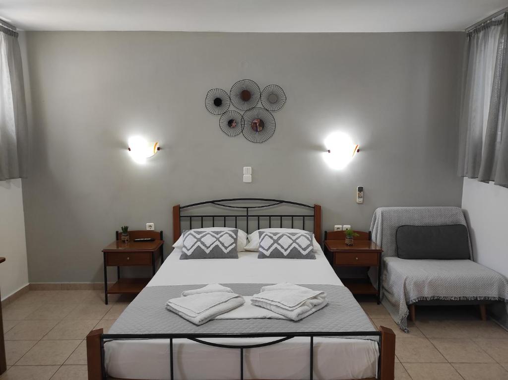 a bedroom with a bed with two towels on it at Vythos in Adamas