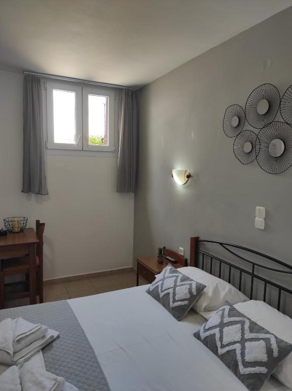 a bedroom with two beds and a window at Vythos in Adamas