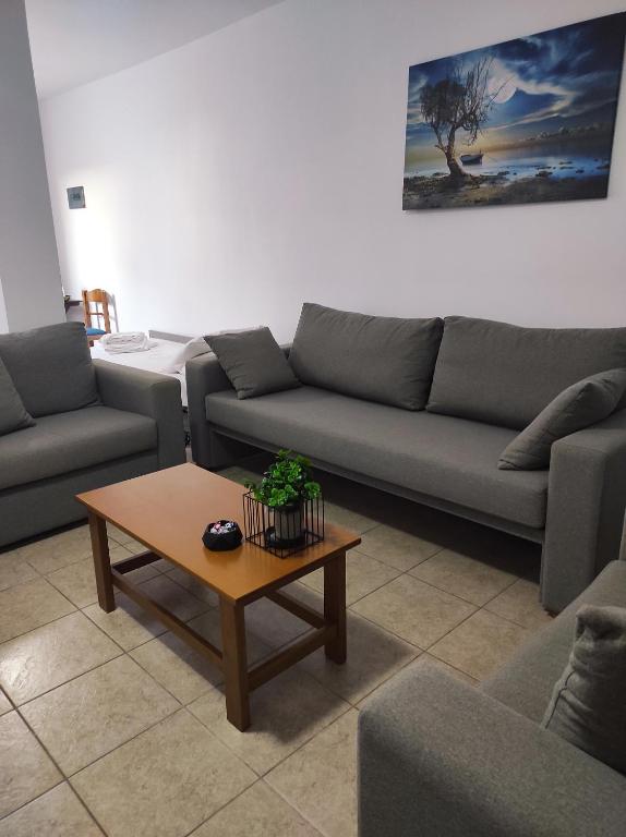 a living room with couches and a coffee table at Vythos in Adamas