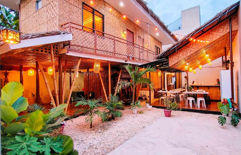 a large building with a courtyard with plants in it at Intoy's Place in Panglao Island