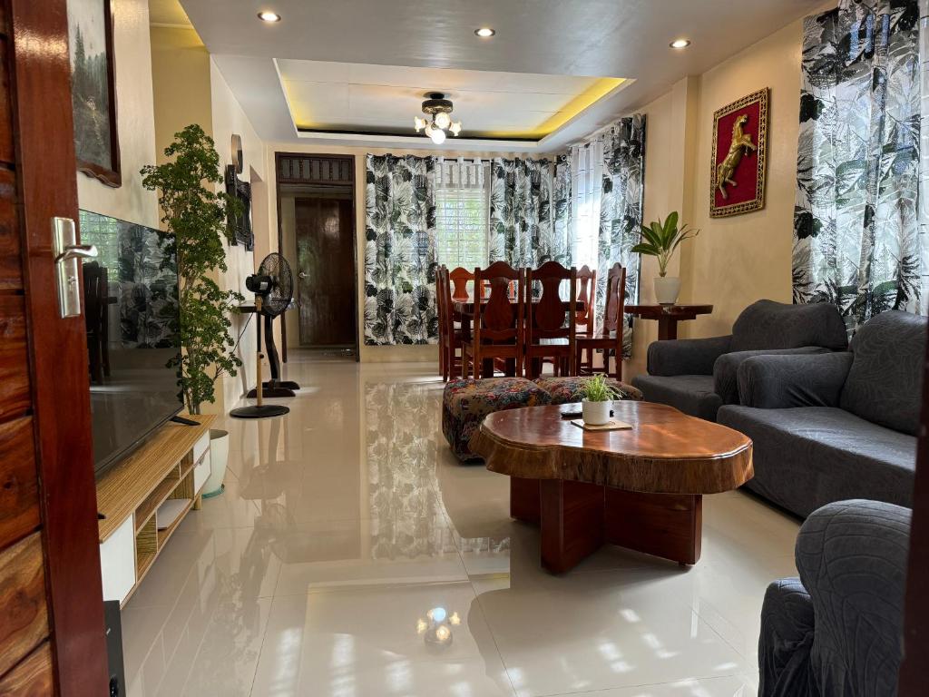 a living room with a couch and a table at The Downtown Cabin Bohol in Tagbilaran City