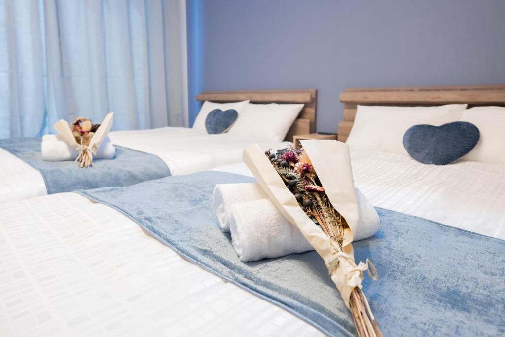 Llit o llits en una habitació de ハッピネスハウス
