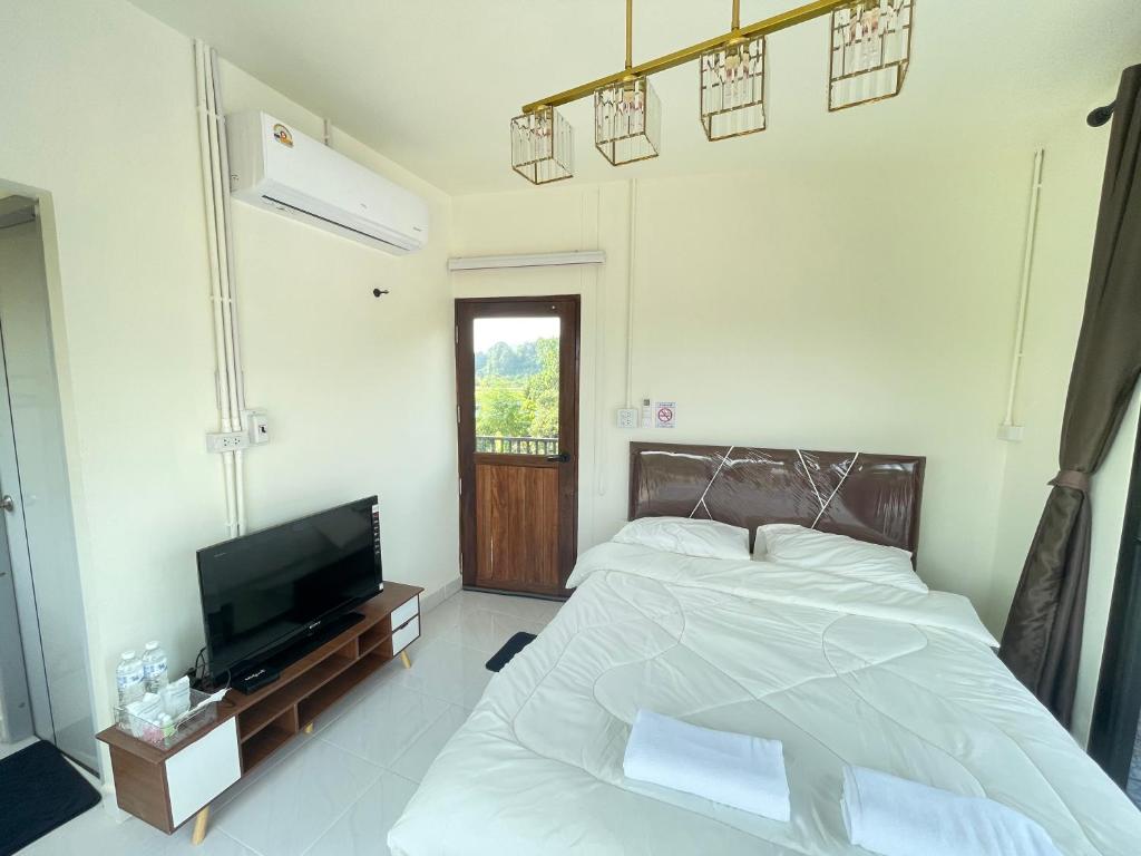 Postel nebo postele na pokoji v ubytování ภูผา เฮ้าส์ รีสอร์ท