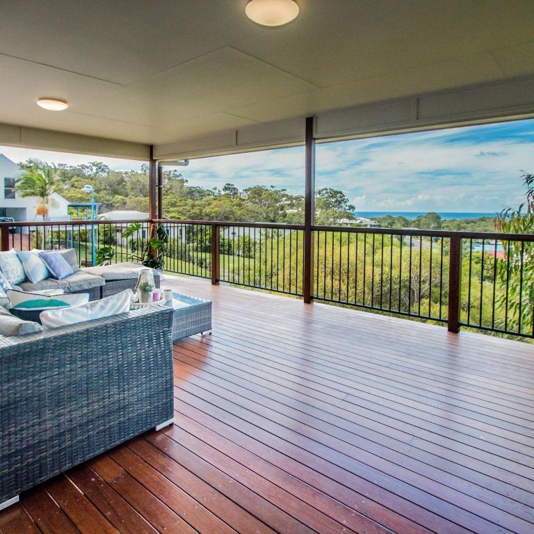 a living room with a couch on a deck at Starfish Beach House in Agnes Water