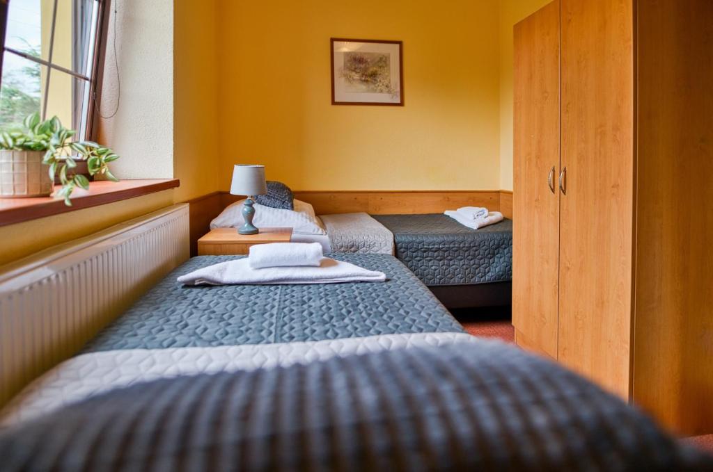 Postel nebo postele na pokoji v ubytování Hotel U Lípy