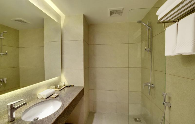 a bathroom with a sink and a shower at Click Hotel Bhuj in Bhuj