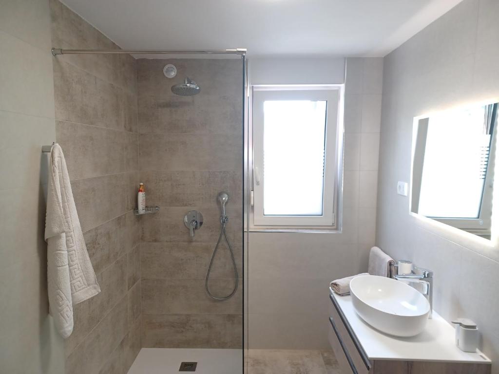 a bathroom with a shower and a sink at Apartments Bobi in Tolmin