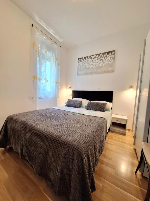 a bedroom with a large bed in a room at Apartments Vjeko in Split