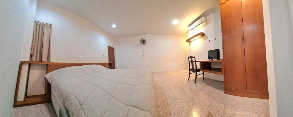 a bedroom with a bed and a desk in it at Banchang home village L in Ban Phayun