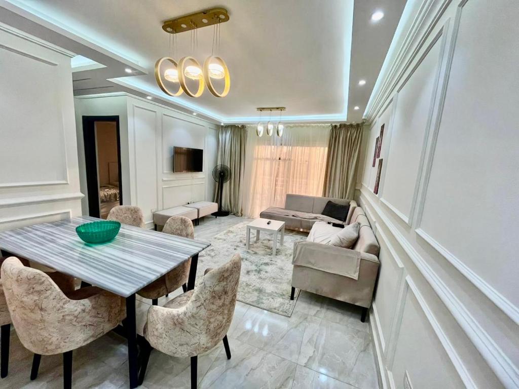 a living room with a table and chairs and a couch at Property Sisters, Elite apartment, B11 in Madinaty