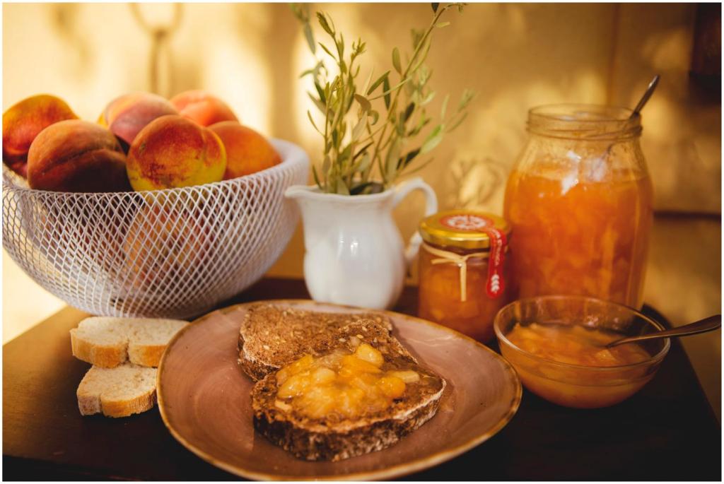 a table with a plate of bread and a bowl of fruit at RTA Costa Etrusca in San Vincenzo