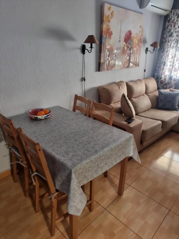 a living room with a table and a couch at Casa La Florida in Orihuela