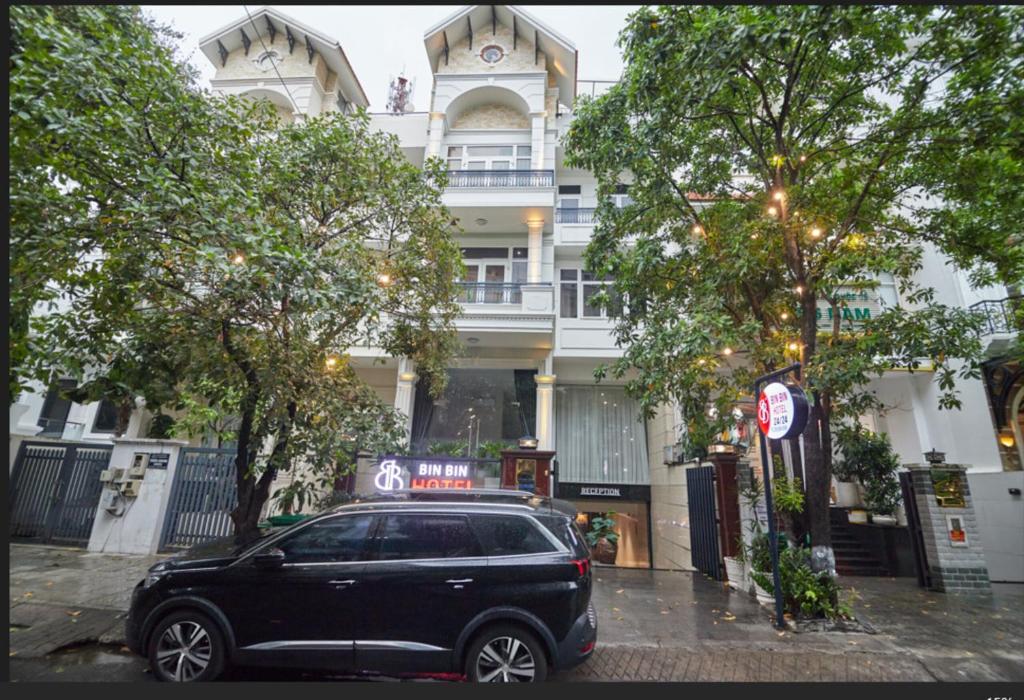 a black suv parked in front of a building at Bin Bin Hotel 2 - Near Him Lam D7 in Ho Chi Minh City