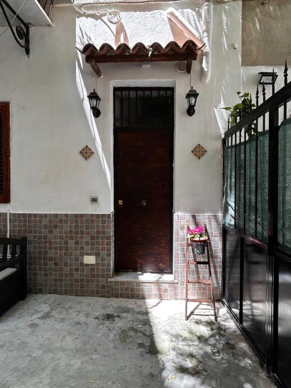 a brown door on the side of a house at Al Cortiletto in Palermo