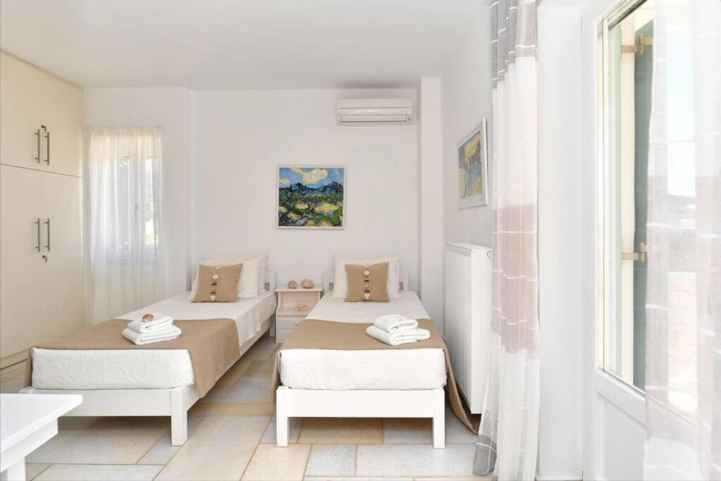 Postel nebo postele na pokoji v ubytování Villa Dionysos in Aliki