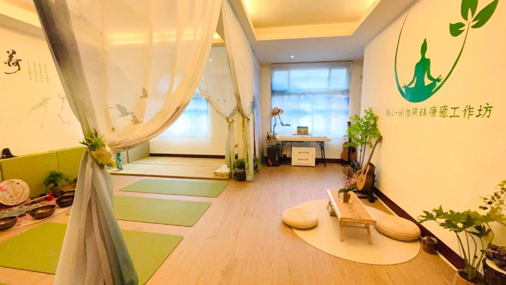 uma sala de estar com piso verde e branco e plantas em 緣心 民宿 em Longtan