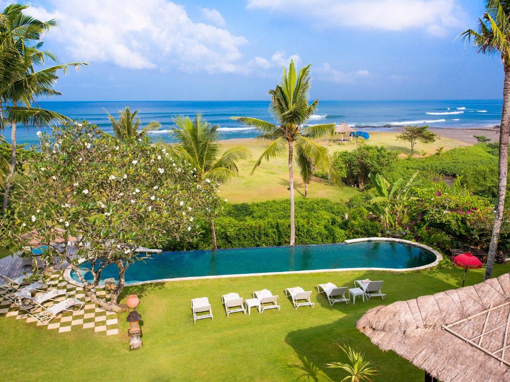 an aerial view of a resort with a swimming pool and the ocean at Sungai Tinggi Beach Villa by Elite Havens in Canggu