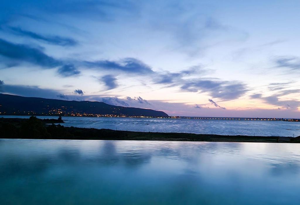 a view of a body of water at sunset at Villa Flamingo Lefkada in Ayía Varvára