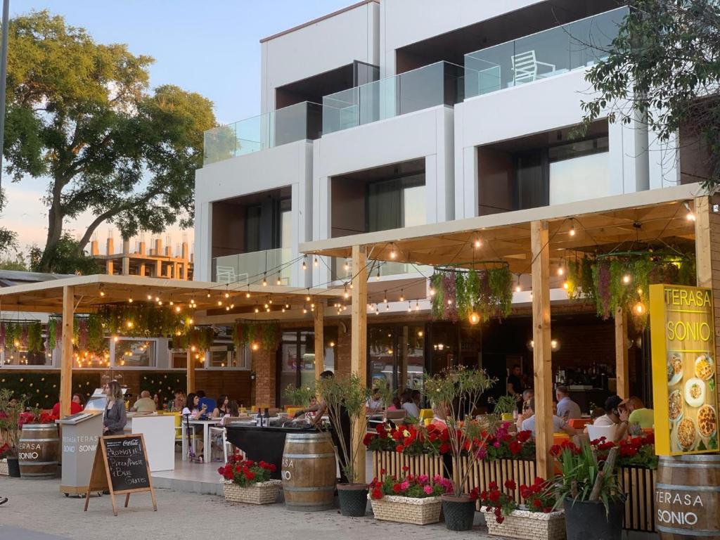 a building with a restaurant in front of it at Sonio Boutique Hotel in Mamaia