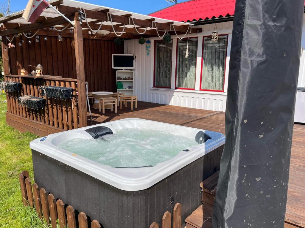 a jacuzzi tub on a deck in a backyard at Slottshuset in Borgholm