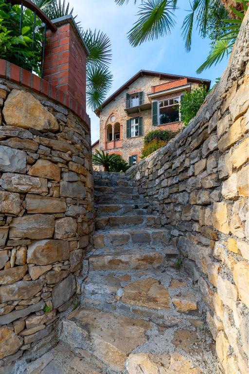 a stone wall with stairs leading up to a building at Villa Rappis in Imperia