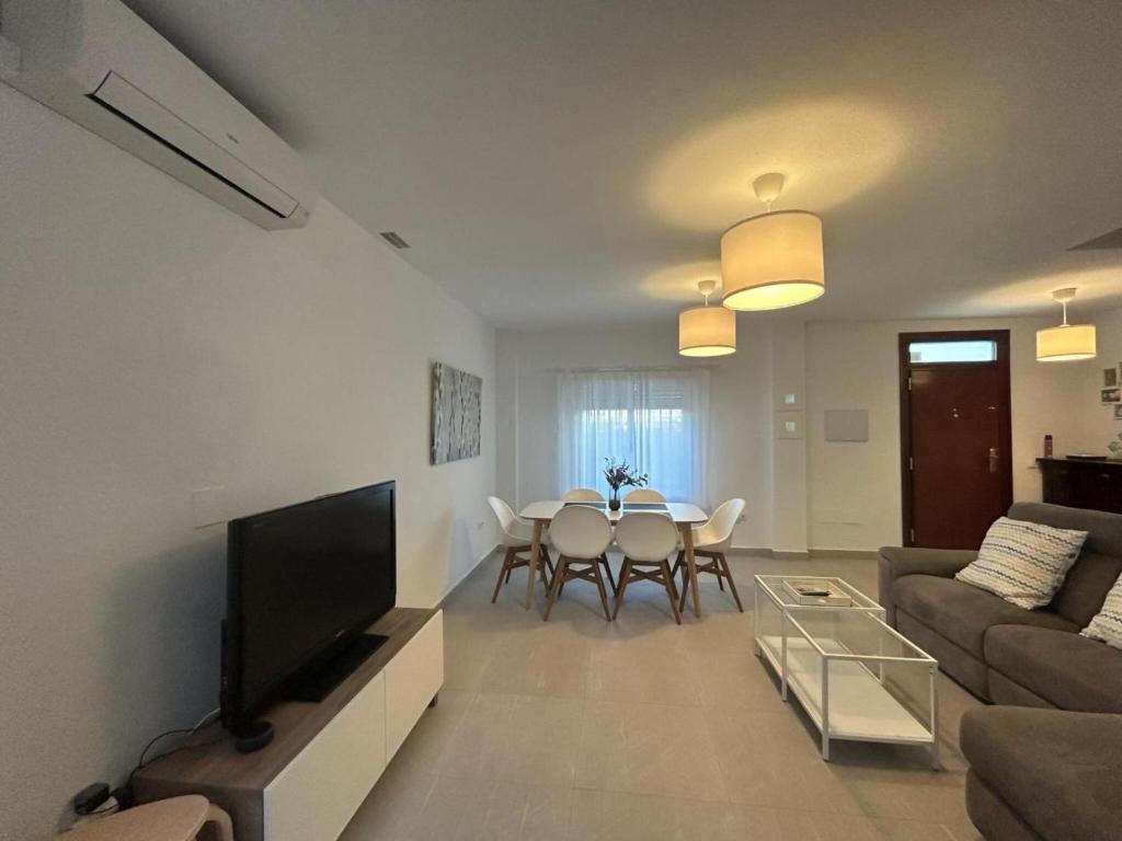 a living room with a couch and a table at Casa de playa los Alamos Andra in Torremolinos