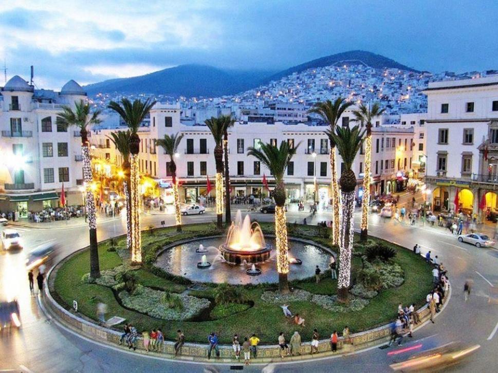a street in a city with palm trees and a fountain at Charming apartment in Central Medina of Tetuan15 min airport in Tetouan