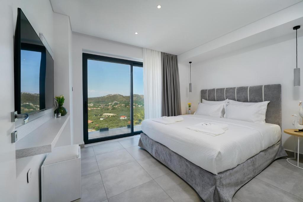 Postel nebo postele na pokoji v ubytování Kefi Luxury Villas