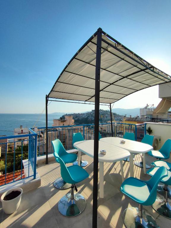 a patio with a table and chairs on a roof at Island House Kavala in Kavála