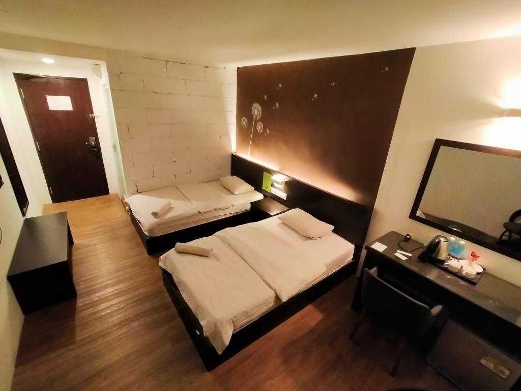 Postel nebo postele na pokoji v ubytování The Grace Hotel