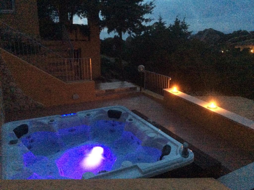 a small swimming pool at night with purple lights at Villetta Vista Mare in Costa Paradiso