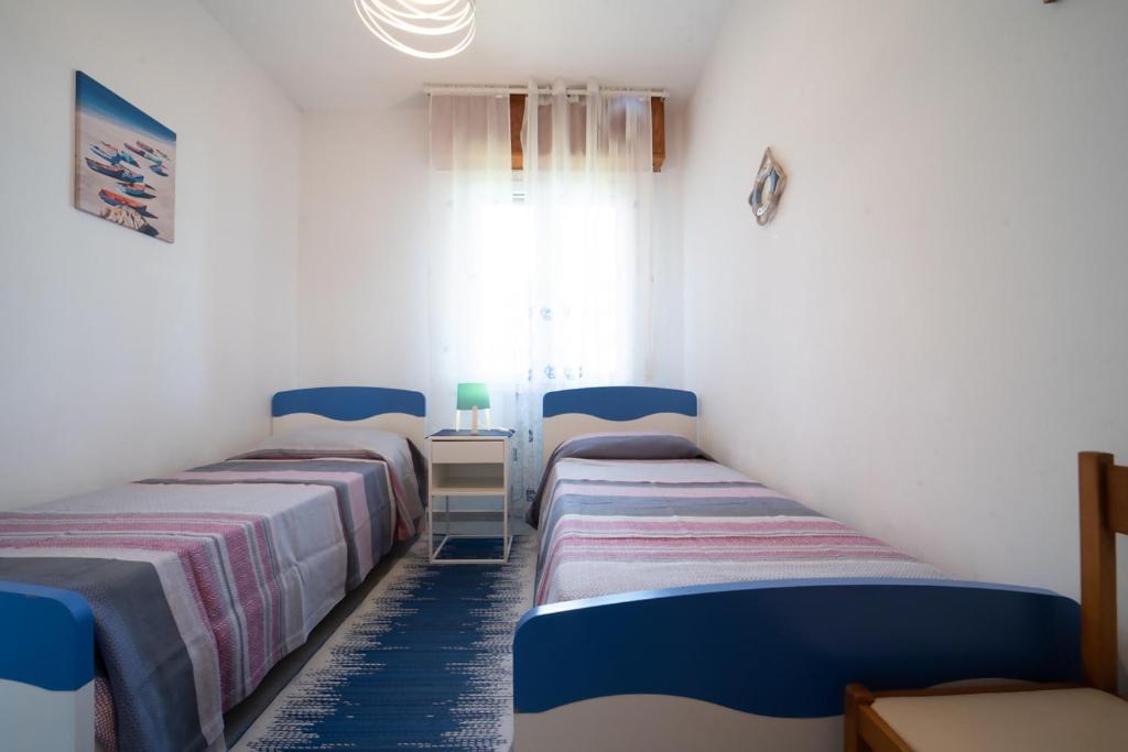 Postel nebo postele na pokoji v ubytování Azzurro lido adriano vista mare