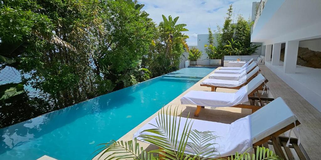 a pool with chaise lounge chairs and a swimming pool at Villa Hafa in Tangier