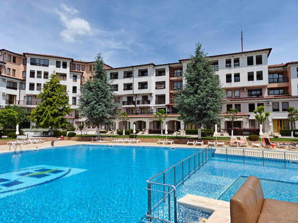 a large swimming pool in front of a building at Apartment Blue Lagoon in Rogachevo