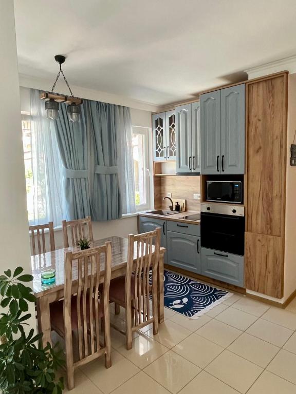 a kitchen with a table and chairs and a sink at Apartment Blue Lagoon in Rogachevo