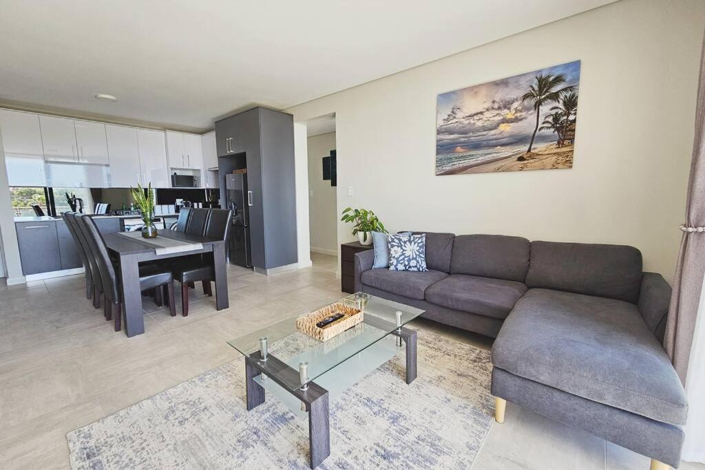 a living room with a couch and a table at 8 at Bella Mare Estate in Gqeberha