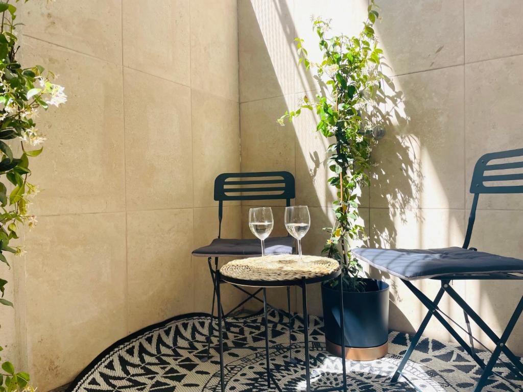 - deux verres de vin assis sur une table sur une terrasse dans l'établissement La Maison by Simone, la vrai, à Cannes