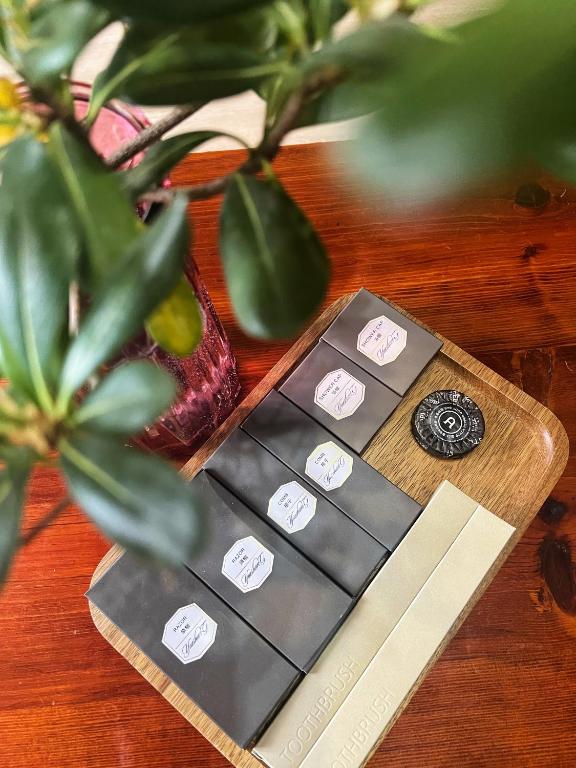 a wooden table with a plant and a game controller at 原乡文苑客栈 in Lijiang