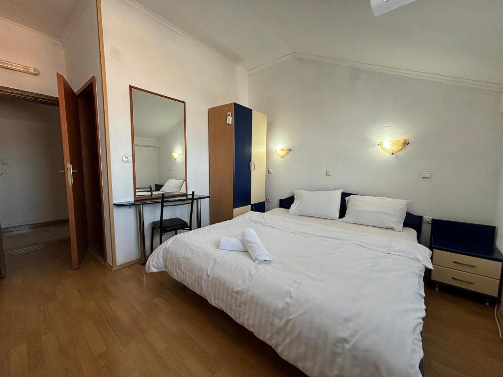 a bedroom with a large white bed and a desk at Villa KiWi in the Heart of Ohrid in Ohrid