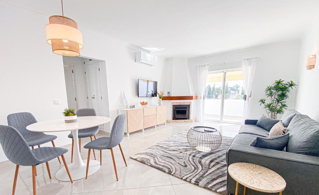 a living room with a couch and a table at Casa Joao in Carvoeiro