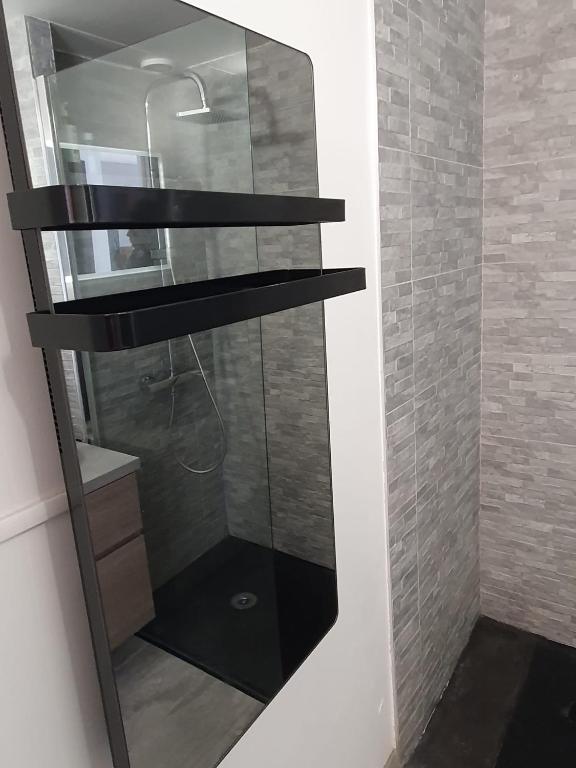 La salle de bains est pourvue d'une douche et d'une étagère en verre. dans l'établissement Katikias, à Bandol