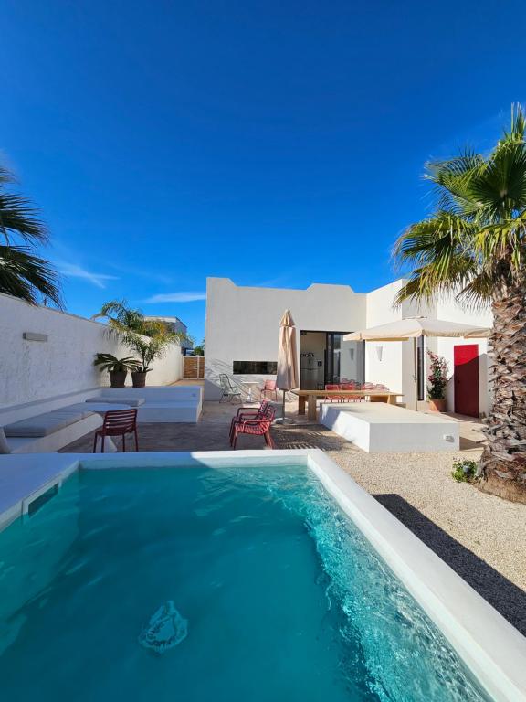 a swimming pool in front of a villa at Casa Aria by Jdvacanze in San Pietro in Bevagna