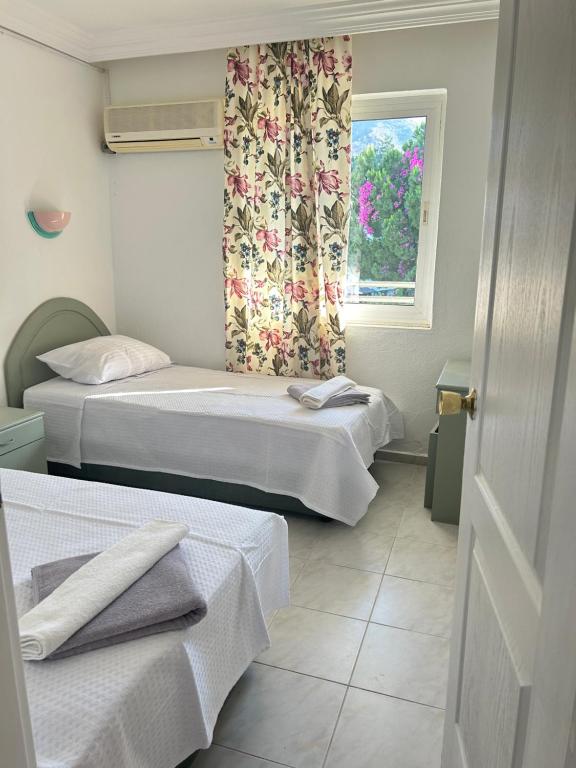 a room with two beds and a window at Family Apart in Marmaris