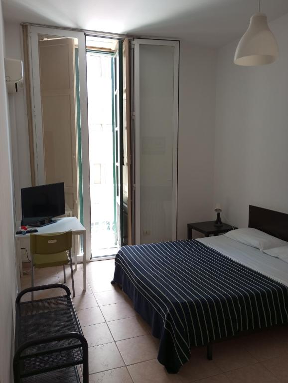 Posteľ alebo postele v izbe v ubytovaní B&B CARAVAGGIO SIRACUSA 200 Metres from Ortigia
