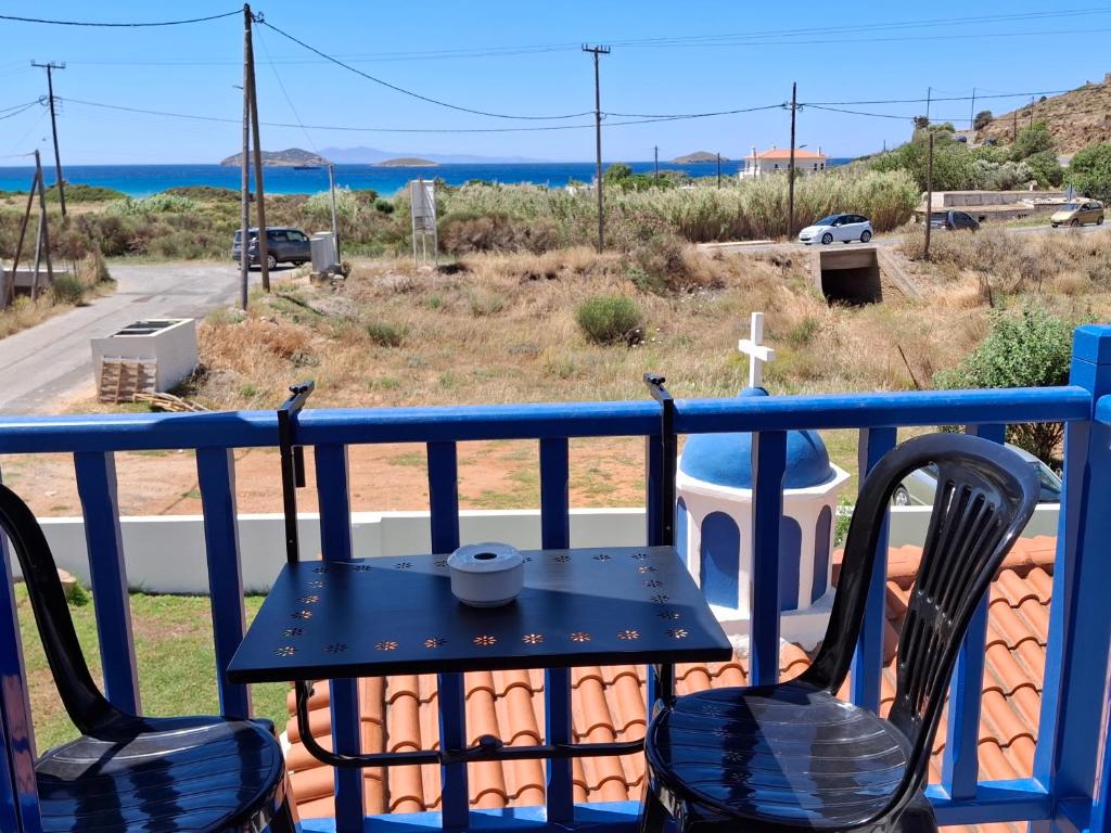 a table and chairs on a balcony with a view of the ocean at RESTIA in Agios Petros
