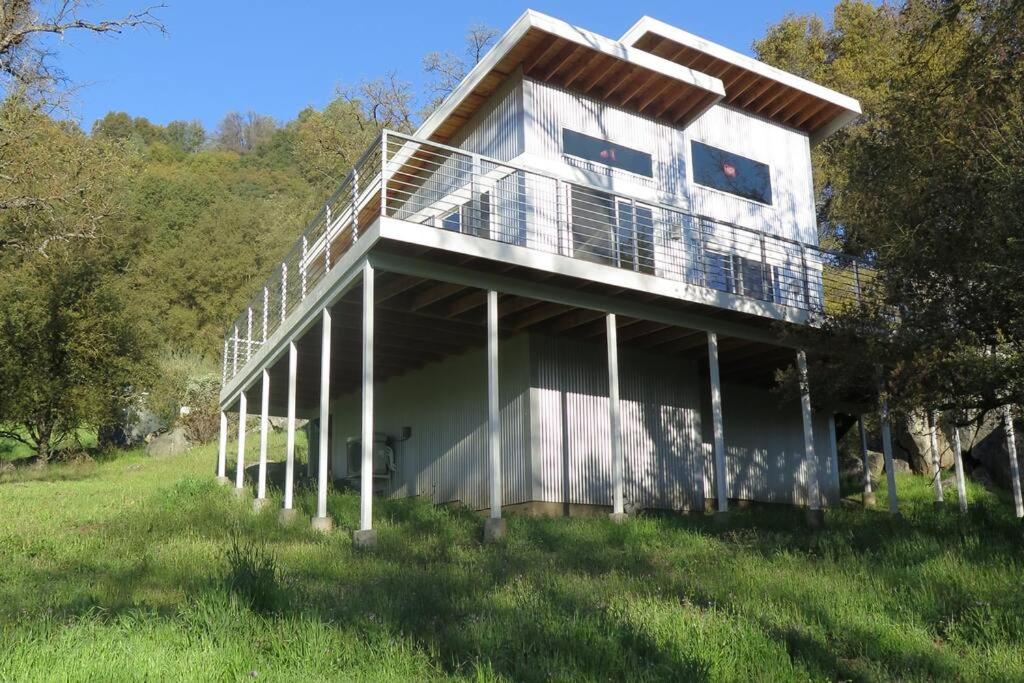 a house with a balcony on the side of it at Loyah Cabin in Ahwahnee