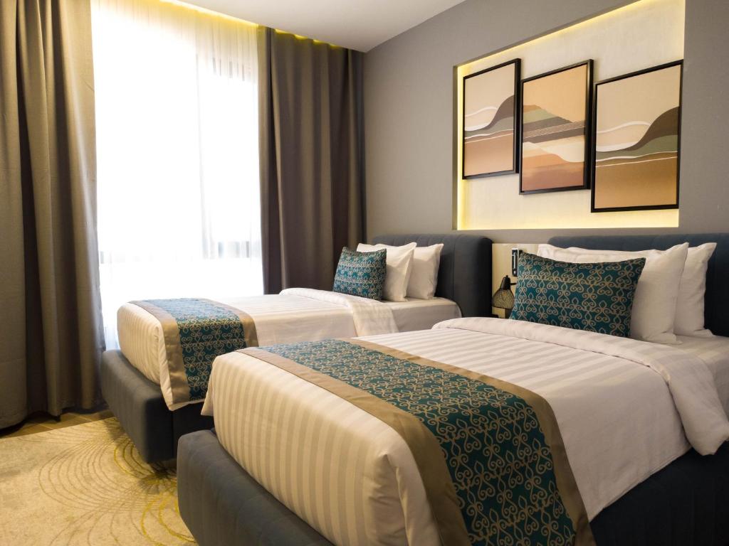 Postel nebo postele na pokoji v ubytování FASQ Hotel