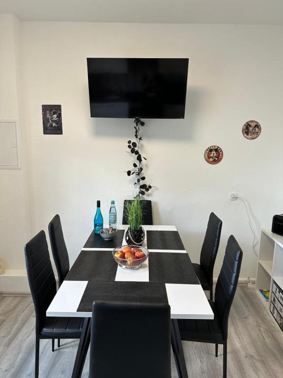 a black and white dining room with a table and chairs at Ferienwohnung Knobloch Louis in Oberhausen